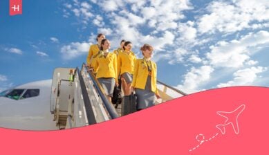 Flight attendants from the best flight attendant school in Australia deboarding a plane at an airport.