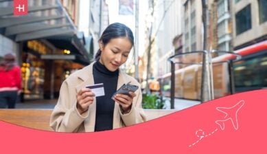 lady using one of the best travel credit cards with no annual fee