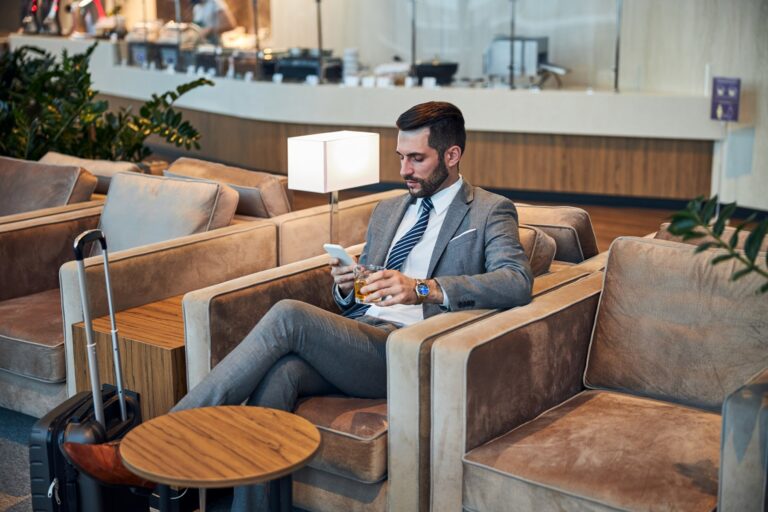 man sitting at one of the best airport lounges