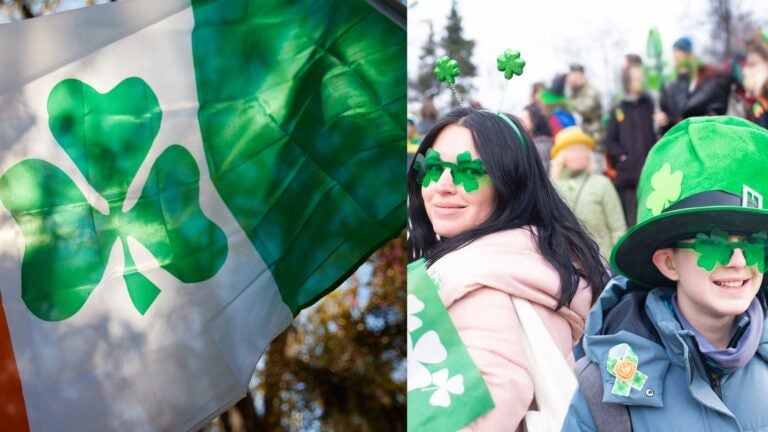 Shamrock flag and paradegoers wearing green accessories for St. Patrick’s Day.