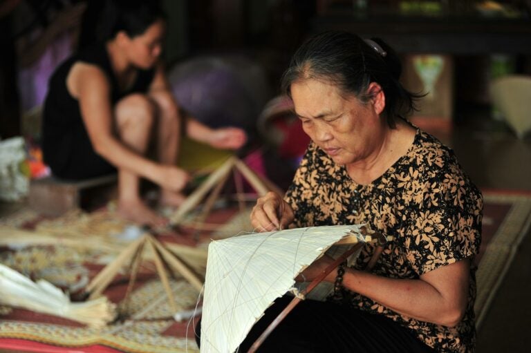 A woman crafting a traditional Vietnamese hat
