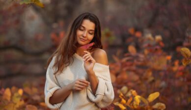 A brunette woman in a cozy, off-shoulder sweater