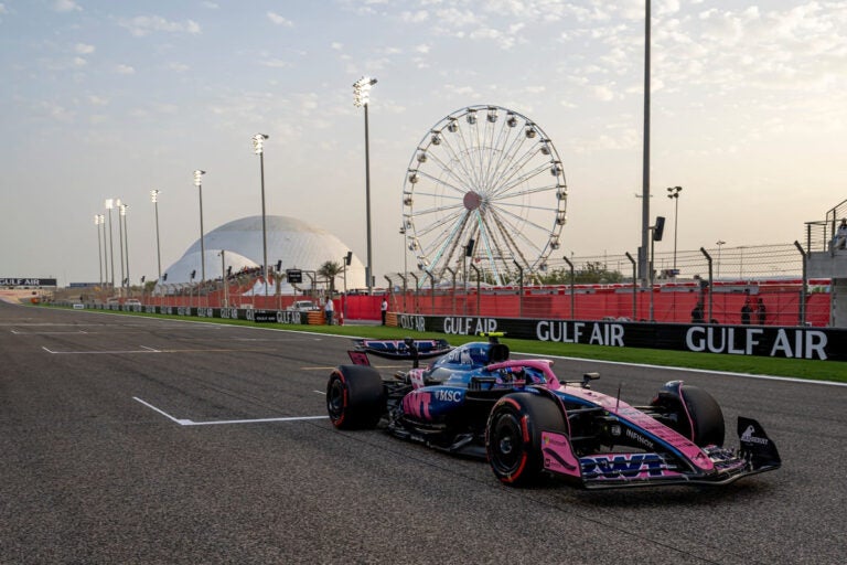 Jack Doohan racing at the 2025 Formula 1 Bahrain Grand Prix in Sakhir during a night race