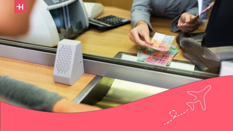 A cashier handing over notebanks to a client in an international bank.