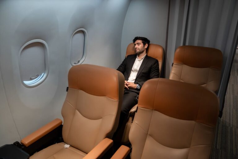Business passenger relaxing comfortably in business class seat during a long haul flight