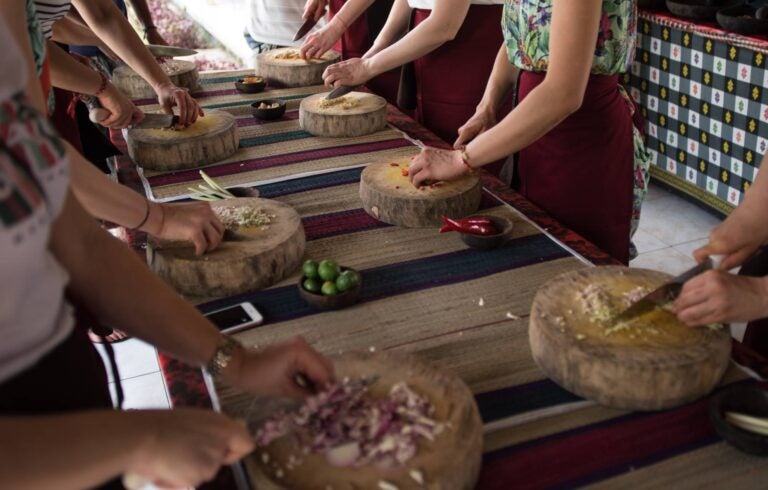 people chopping ingredients in a cooking class