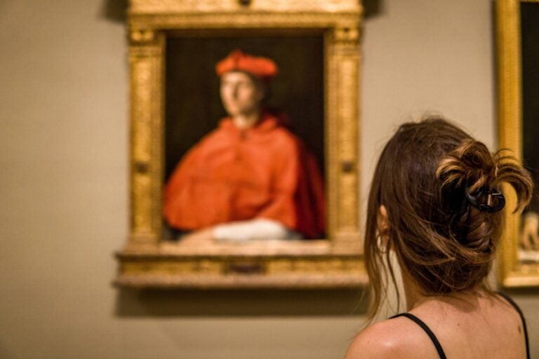 woman looking at a Raphael painting