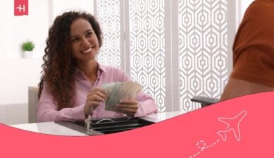 bank teller counting cash for a customer at the bank - best international banks in Australia