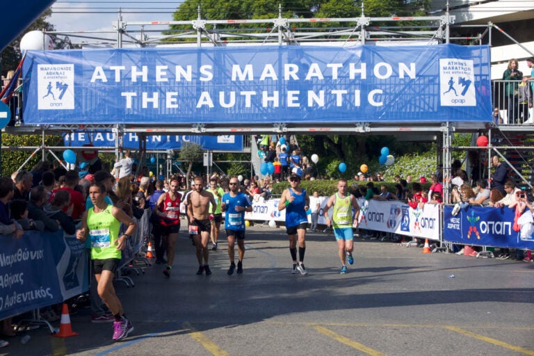 runners finishing athens authentic marathon at panathenaic stadium