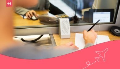 customer with pen and paper writing application at bank office - best international banks in uk