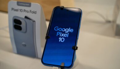 Google Pixel 10 smartphone display with Pixel 10 Pro Fold promotional poster in a retail store