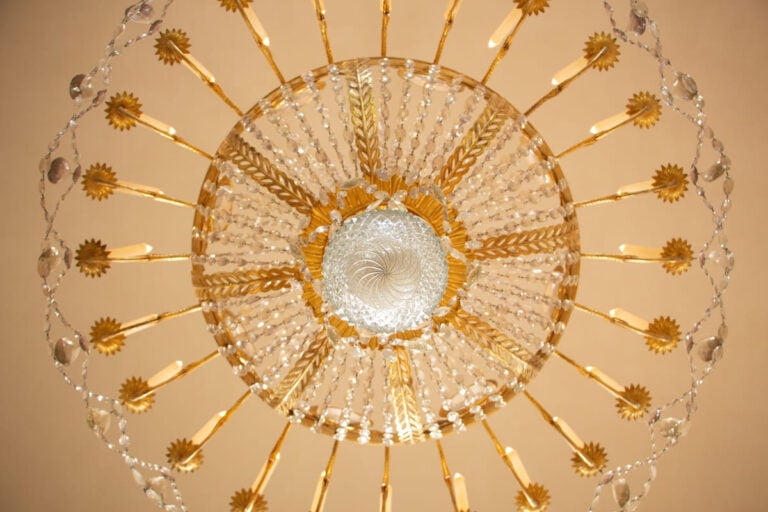 Ornate historic ballroom interior with chandelier similar to those used in Bridgerton filming locations