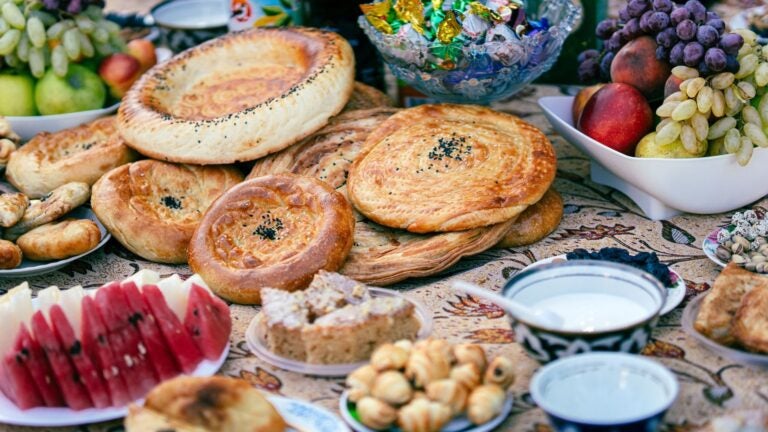 A table of Iranian food, including breads and fruits