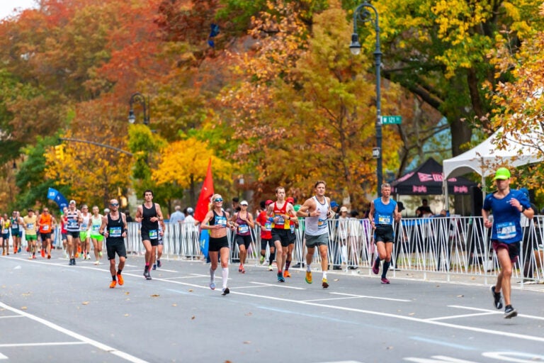 runners passing through harlem during the new york city marathon