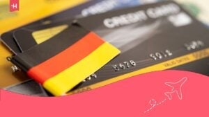 how do you open a bank account in germany as a foreigner? - german flag and three bank cards.