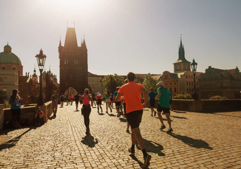 Group of runners competing in the Prague Half Marathon through historic streets of Prague, Czech Republic