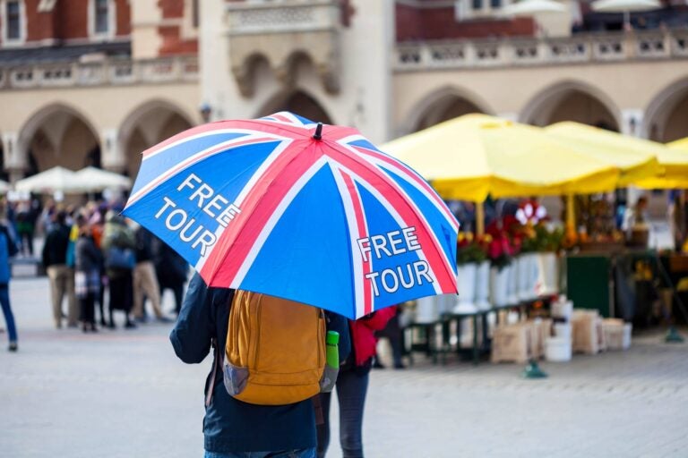 man walking with an umbrella in london