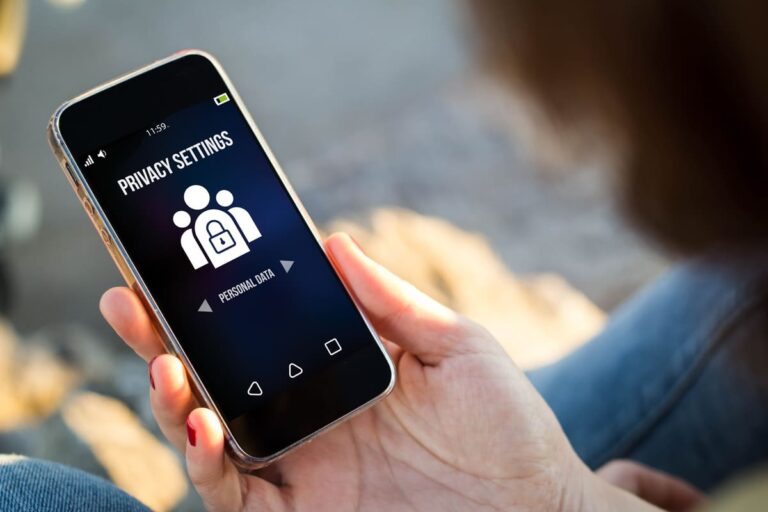 Young woman adjusting privacy settings on her smartphone representing mobile security and personal data protection