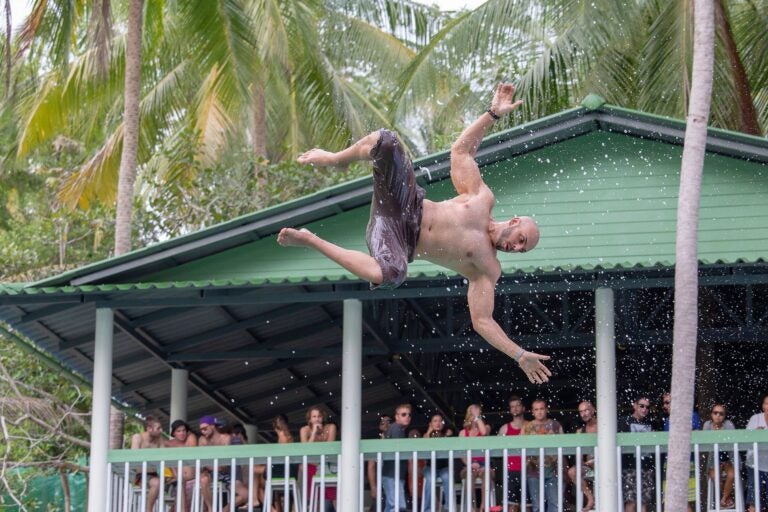 A man jump in the pool in the attraction Slip N Fly.