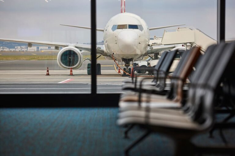Aircraft being refueled on the tarmac at an international airport departure area