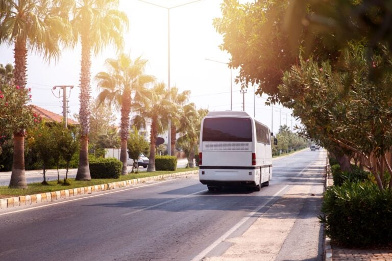 A shuttle bus conveying passengers from the airport to the best car rental company office in Alicante.