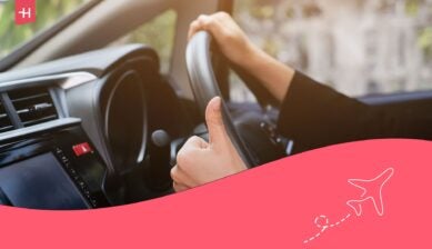 A man driving through cities in a car from the best car rental company in Canada.