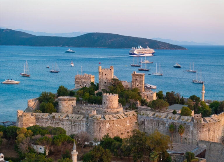 Aerial drone view of Bodrum city, castle, beach, and marina in Muğla province, Turkey