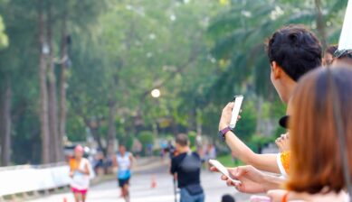 Crowd of spectators cheering on runners during a city marathon