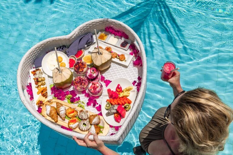 woman holding a basket with food in a pool
