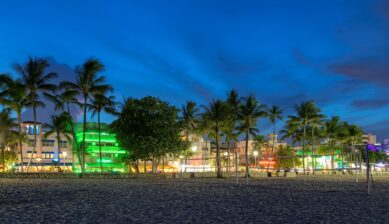 Miami Beach Ocean Drive lit up at night with hotels and restaurants during Grand Prix weekend