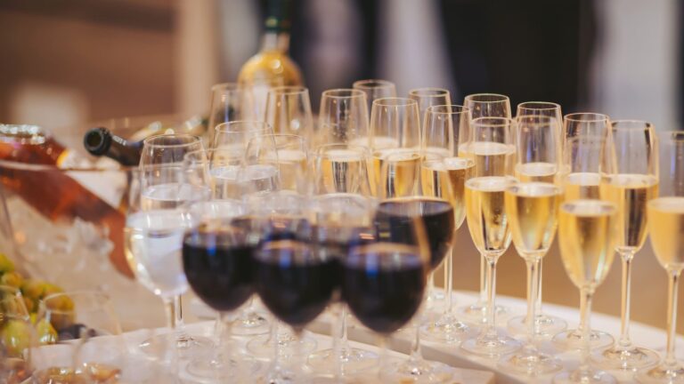 Sparkling and red wine glasses arranged at an elegant VIP gathering during Miami Grand Prix weekend