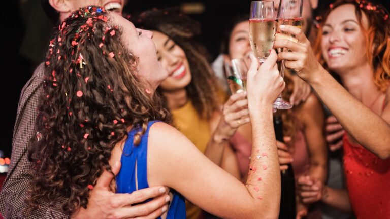 Friends celebrating with champagne at the Miami Grand Prix weekend party
