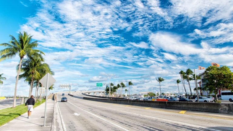 Miami highway and urban skyscrapers near the port against a blue sky in Miami-Dade