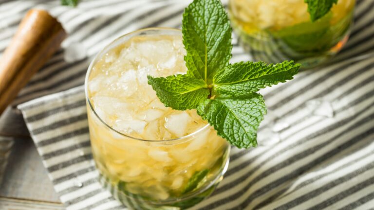 A homemade mint julep cocktail with fresh mint and Kentucky bourbon served over crushed ice