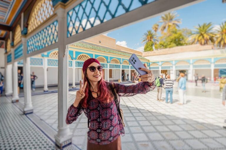 woman taking a photo inside a moroccan temple