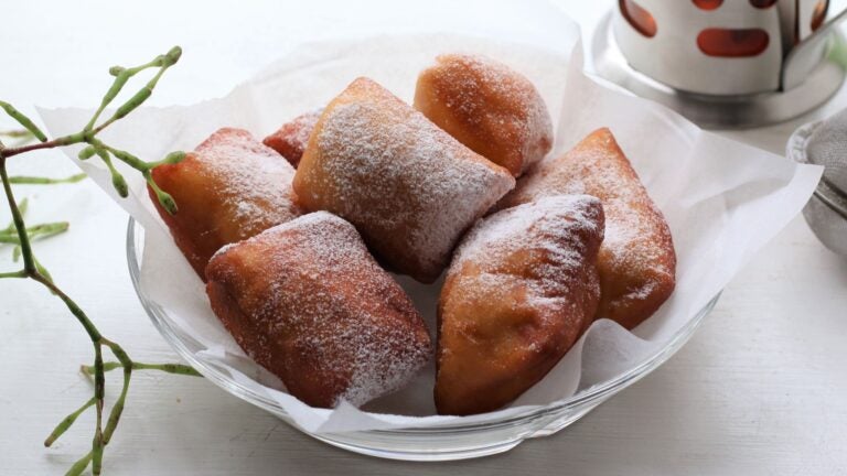 Square New Orleans-style beignets dusted with powdered sugar at Jazz Fest
