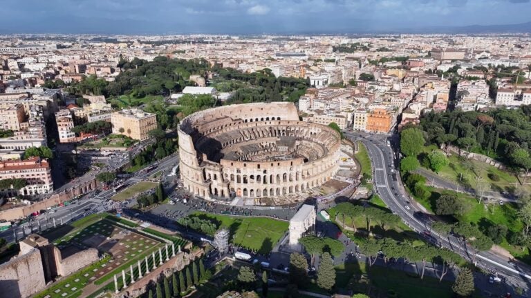 Aerial view of the Rome Colosseum surrounded by the city skyline in spring