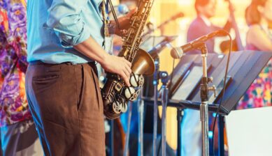 Saxophonist performing live with a band at a jazz music festival
