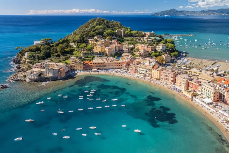 Aerial view of Sestri Levante in Liguria, Italy, with sandy beach, fishing boats, and historic buildings