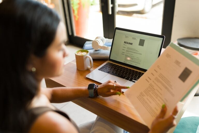 A future intern reviewing her resume and cover letter on a laptop. 