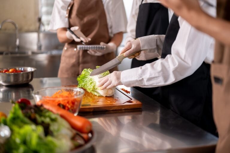 Young chef in the kitchen doing a culinary internship.