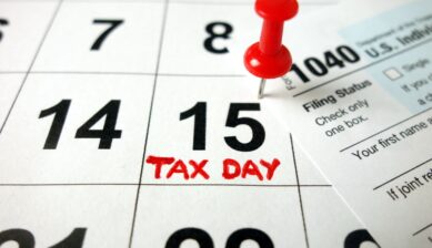 Calendar open to April 15 beside a 1040 tax form, representing US Tax Day