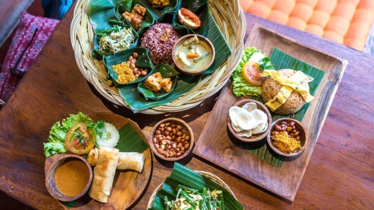 Spread of traditional Balinese and Indonesian dishes served on a table