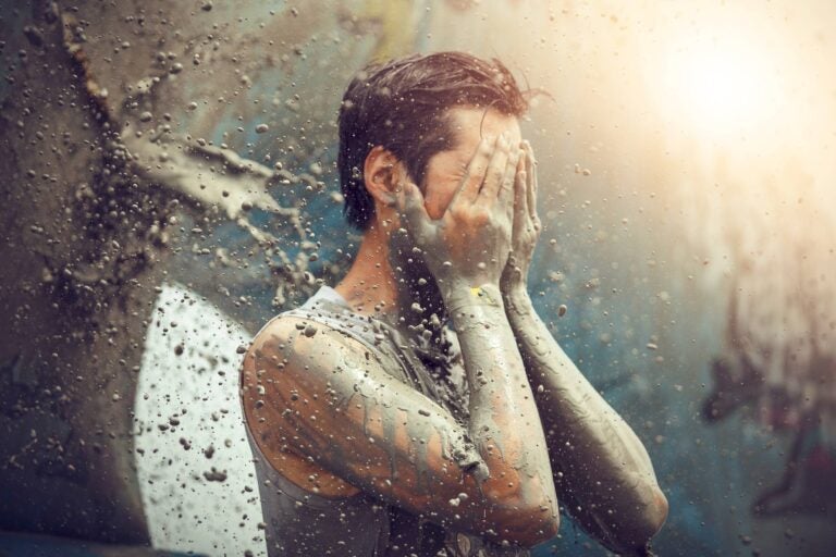person throwing mud to himself