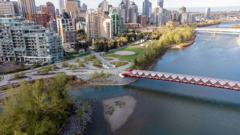 An aerial view of downtown Calgary and the Peace Bridge along the Bow River