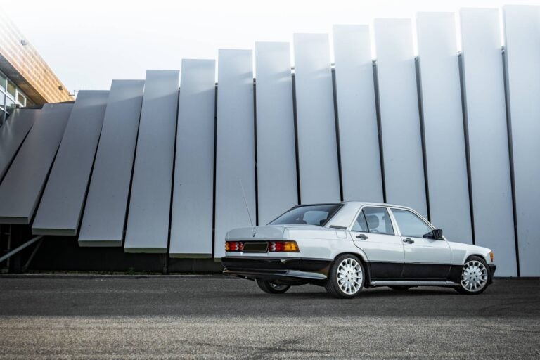 a classic mercedes benz with a grey wall at the bottom