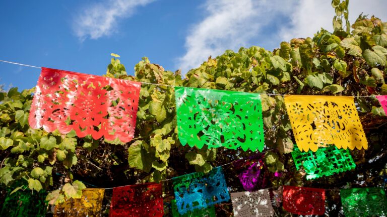 Colorful papel picado flags hanging above Olvera Street in Los Angeles, California, during Cinco de Mayo celebrations