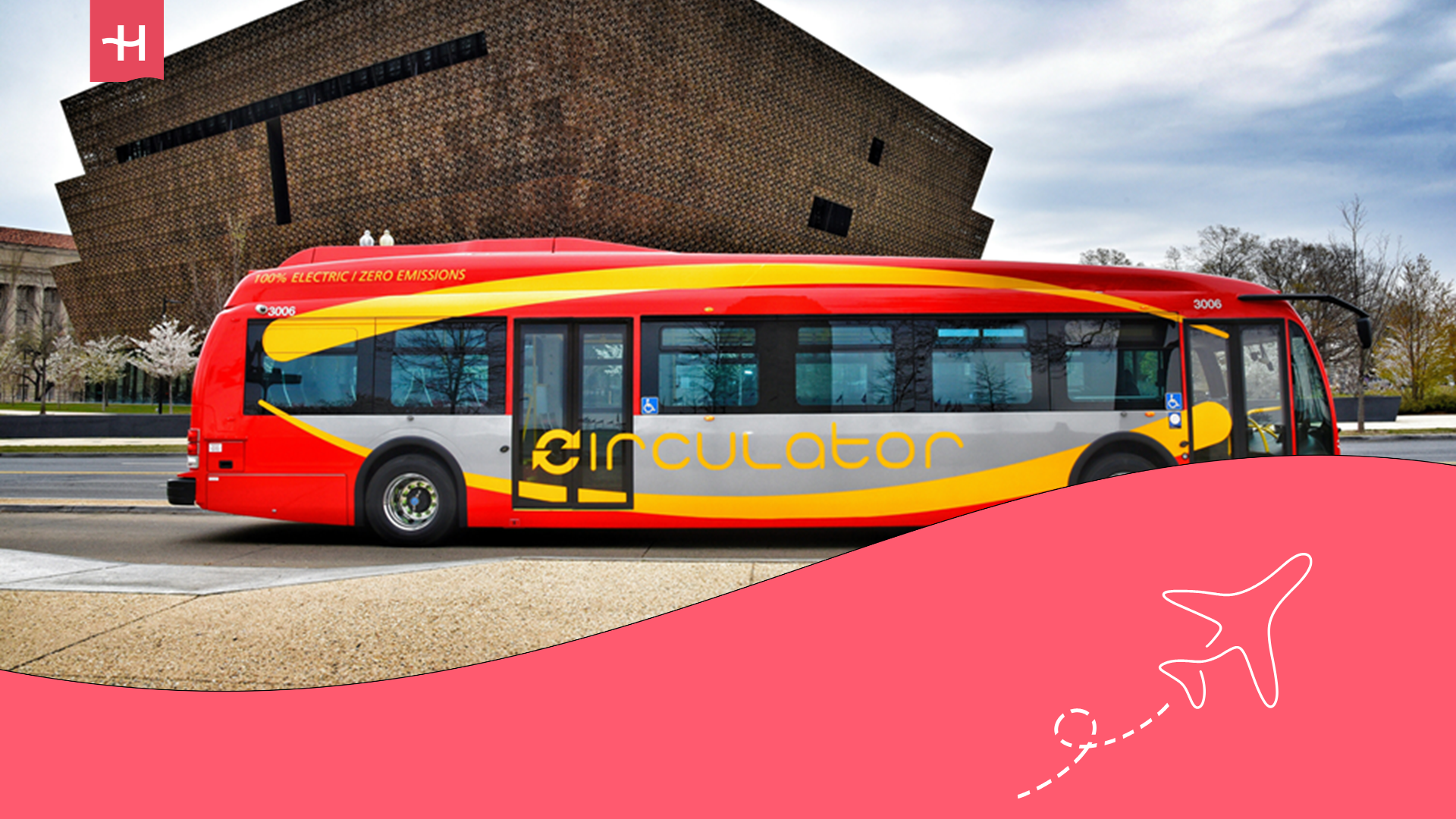 Manchester public bus on urban street near city landmarks.