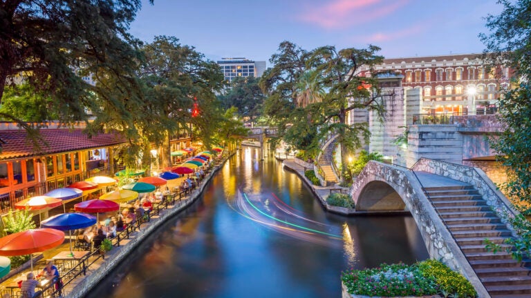 San Antonio River Walk at sunset with downtown skyline reflected on the water, Texas, USA