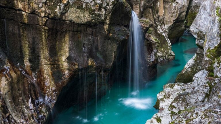 Emerald-green Soča River winding through a canyon in Triglav National Park, Slovenia